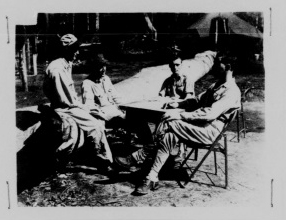 October 1944 Photograph showing the interrogation of three member of a crew rescued on Ceram Island after a hand-to-hand battle with Japanese soldiers. Left to Right:  1st Lt. MARK INGRAM, Bombardier; Lt. Col. TRUMAN A. SPENCER, JR. Pilot; T/Sgt. Nicholas J. Lopresti, radio operator; Major MATTHIAS LITTLE, JR., S-2 Officer, interrogating.